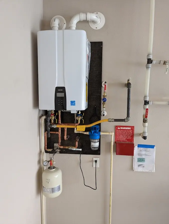 Professional plumber installing copper piping in a Aquia Harbour home